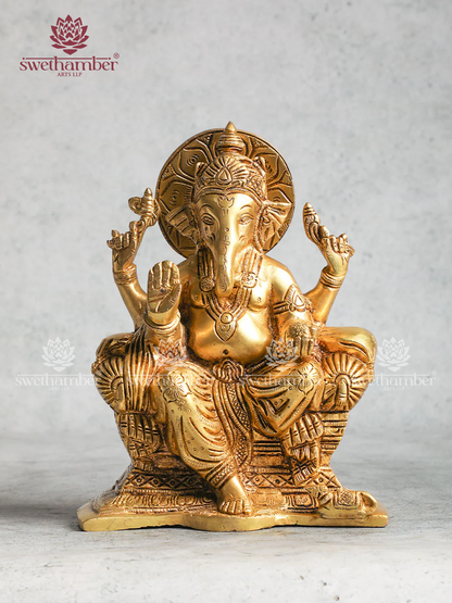 Brass Ganesha statue sitting On Sofa