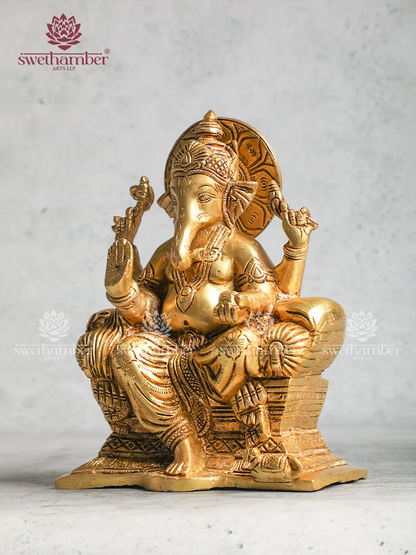Brass Ganesha statue sitting On Sofa