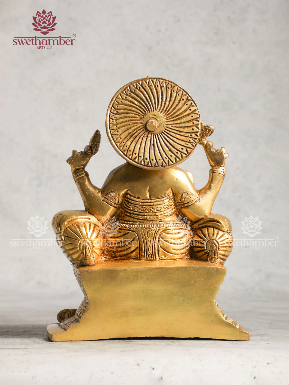 Brass Ganesha statue sitting On Sofa