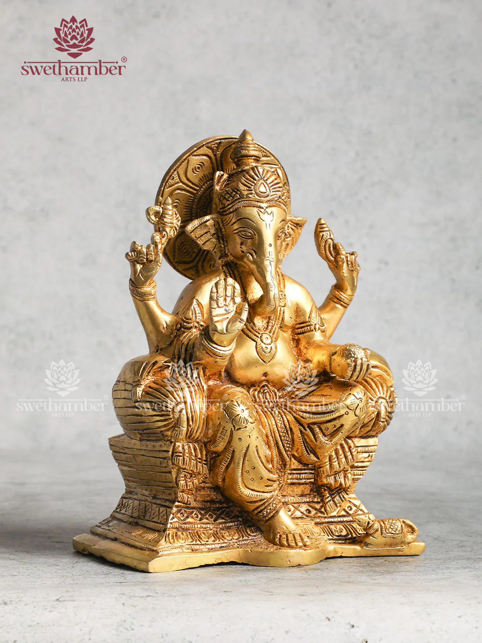 Brass Ganesha statue sitting On Sofa