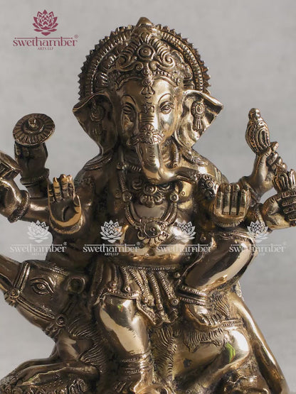 Brass Ganesha sitting on mouse